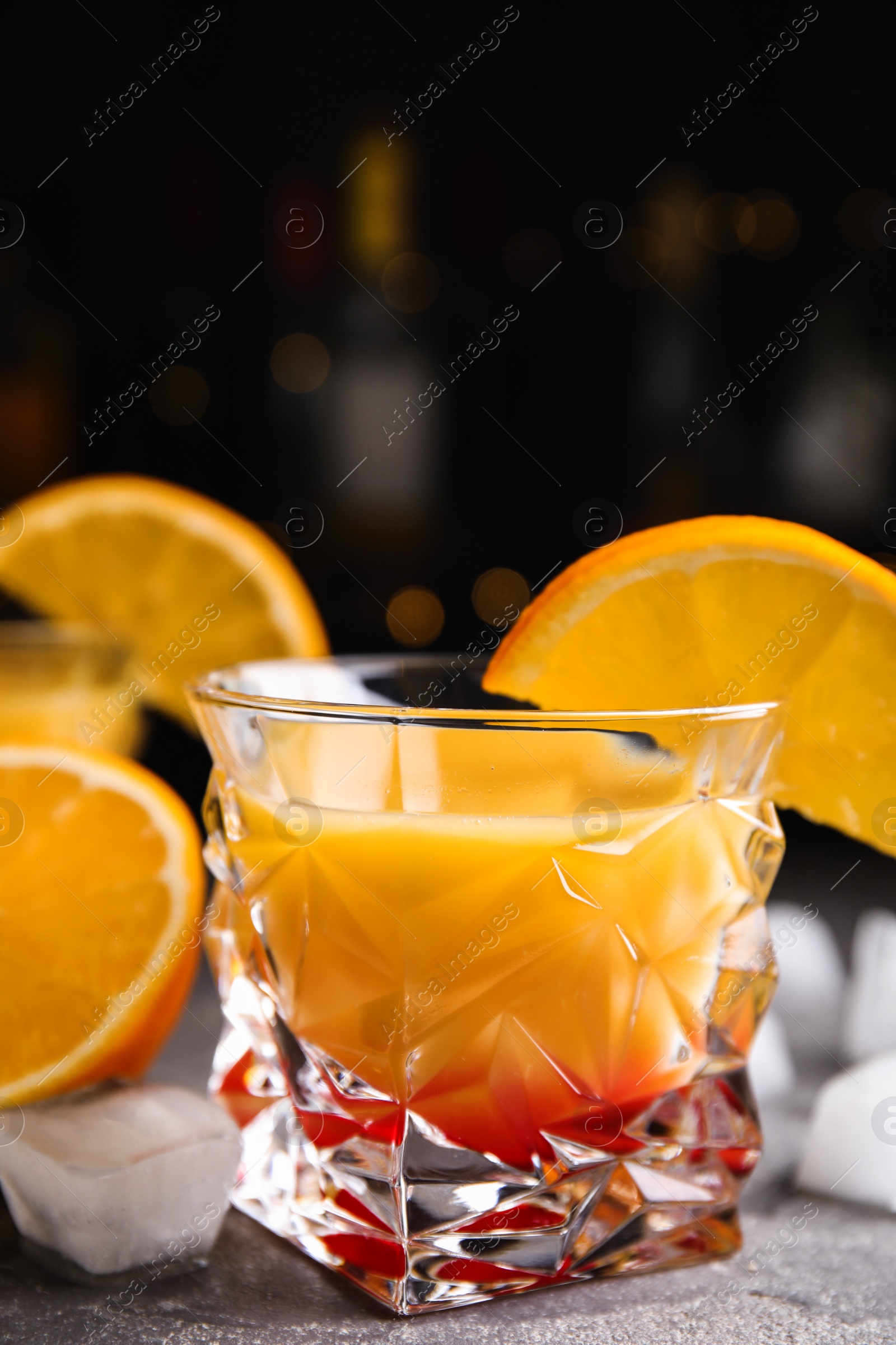 Photo of Fresh alcoholic Tequila Sunrise cocktail on grey table