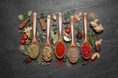 Photo of Flat lay composition with different natural spices and herbs on black table