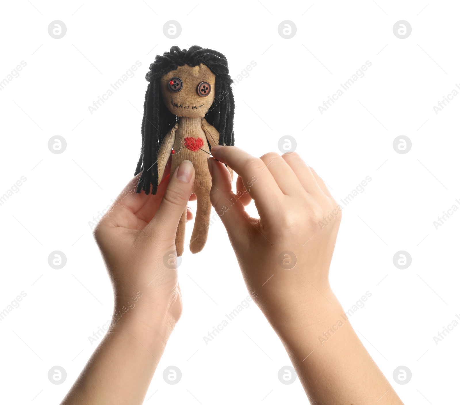 Photo of Woman stabbing voodoo doll with pin on white background, closeup