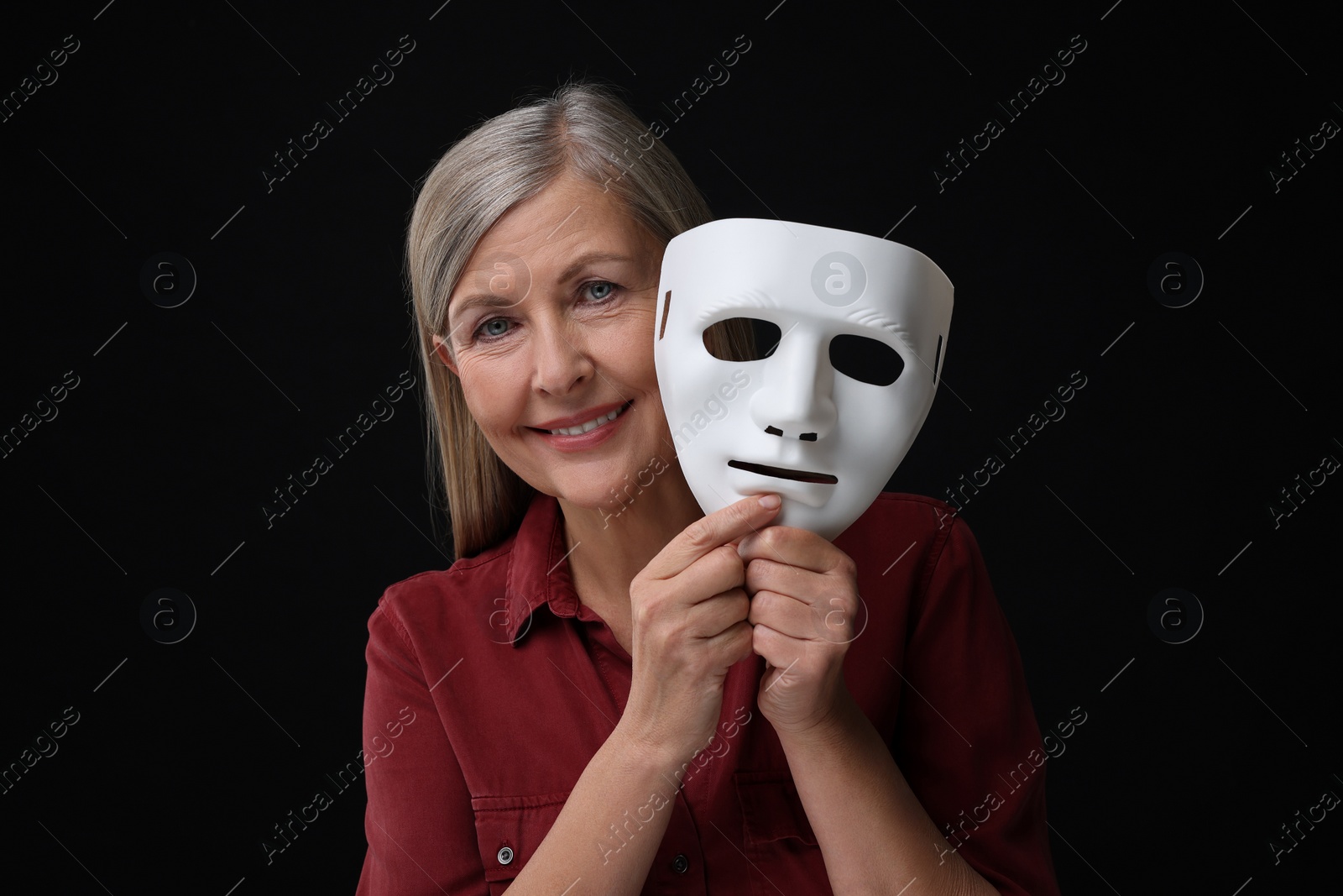 Photo of Multiple personality concept. Woman with mask on black background