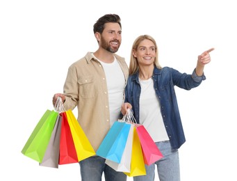 Photo of Family shopping. Happy couple with many colorful bags on white background