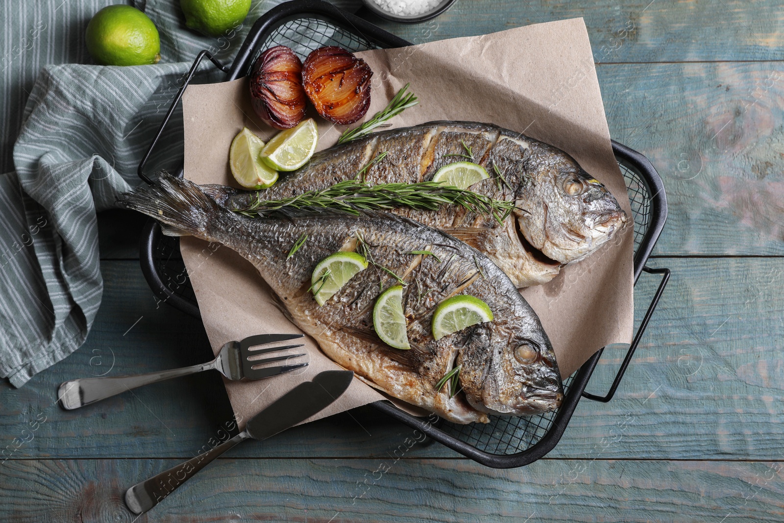 Photo of Delicious baked fish served on wooden rustic table, flat lay. Seafood