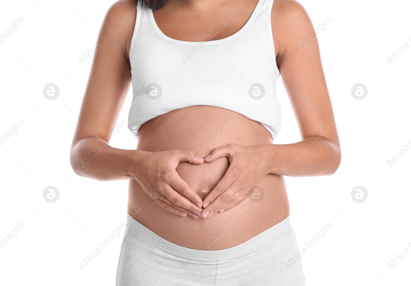 Photo of Pregnant woman posing on white background, closeup