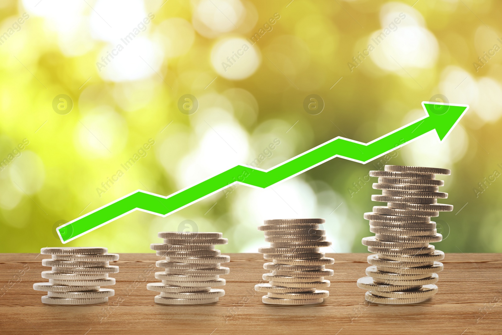 Image of Stacked coins on wooden table against blurred background. Investment concept