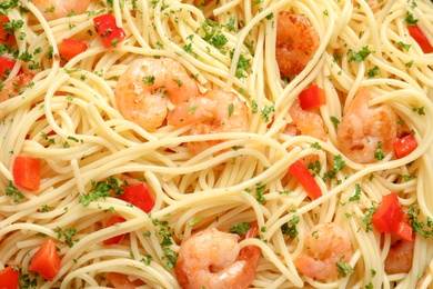 Photo of Delicious spaghetti with shrimps, closeup