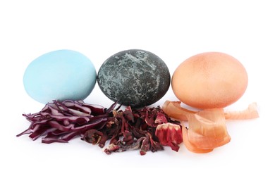 Photo of Naturally painted Easter eggs on white background. Red shredded cabbage, hibiscus and onion used for coloring