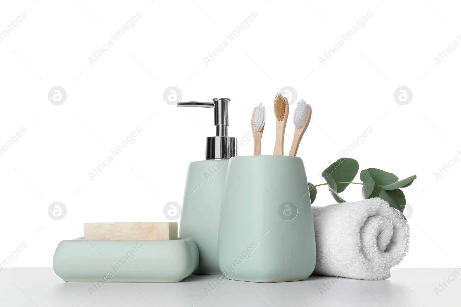 Photo of Bath accessories. Different personal care products and eucalyptus branch on table against white background