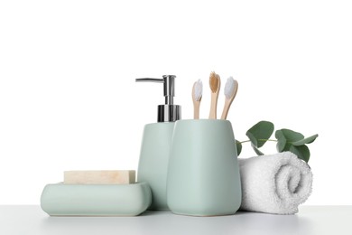 Bath accessories. Different personal care products and eucalyptus branch on table against white background