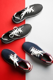 Flat lay composition of stylish training shoes on color background