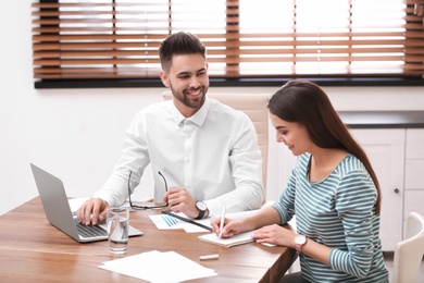 Insurance agent consulting young woman in office