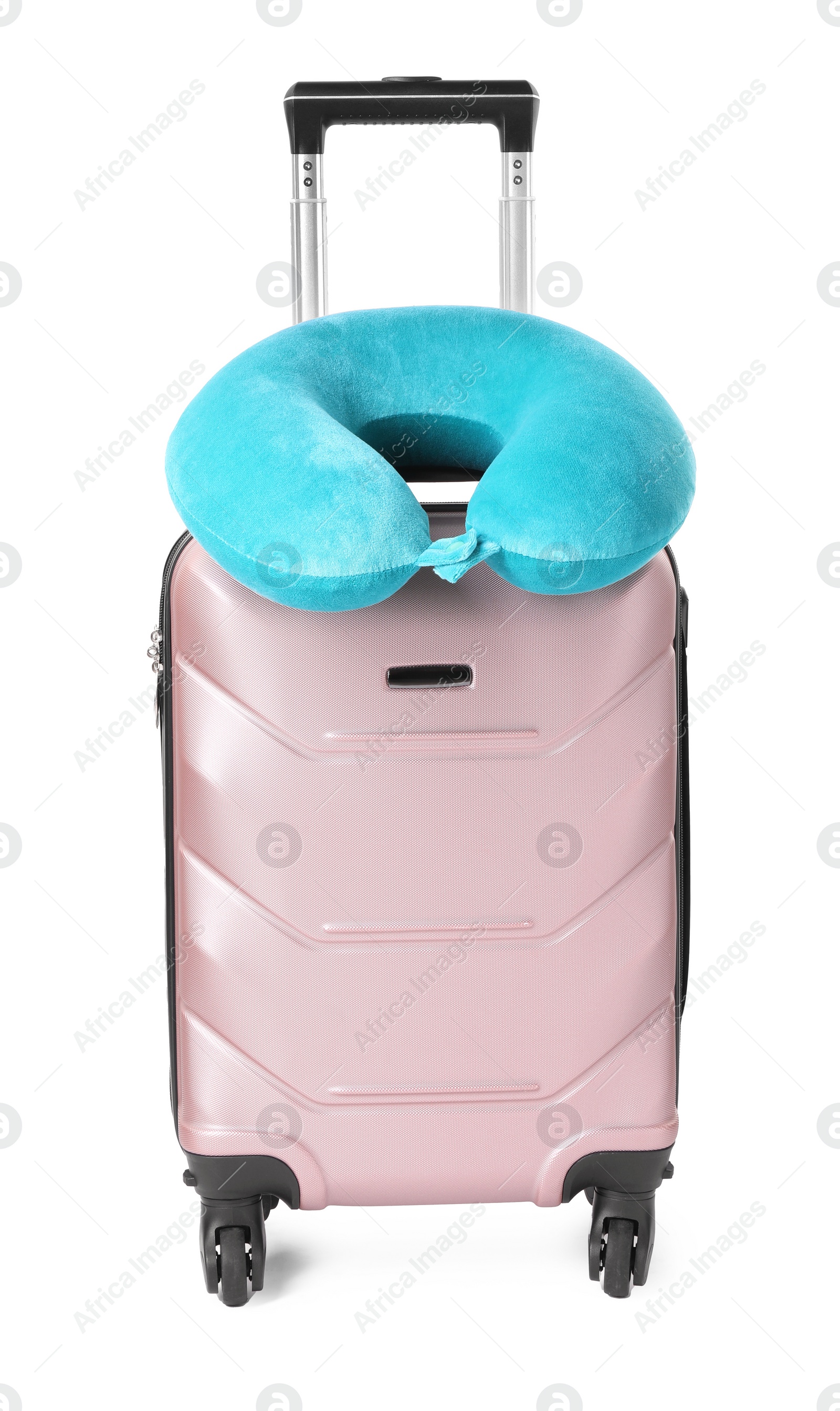 Photo of Light blue travel pillow on suitcase against white background