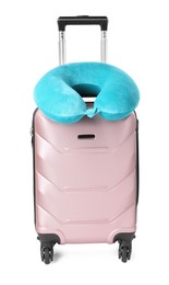 Photo of Light blue travel pillow on suitcase against white background