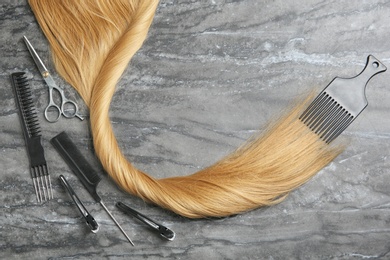 Photo of Flat lay composition with hair salon tools and space for text on grey background