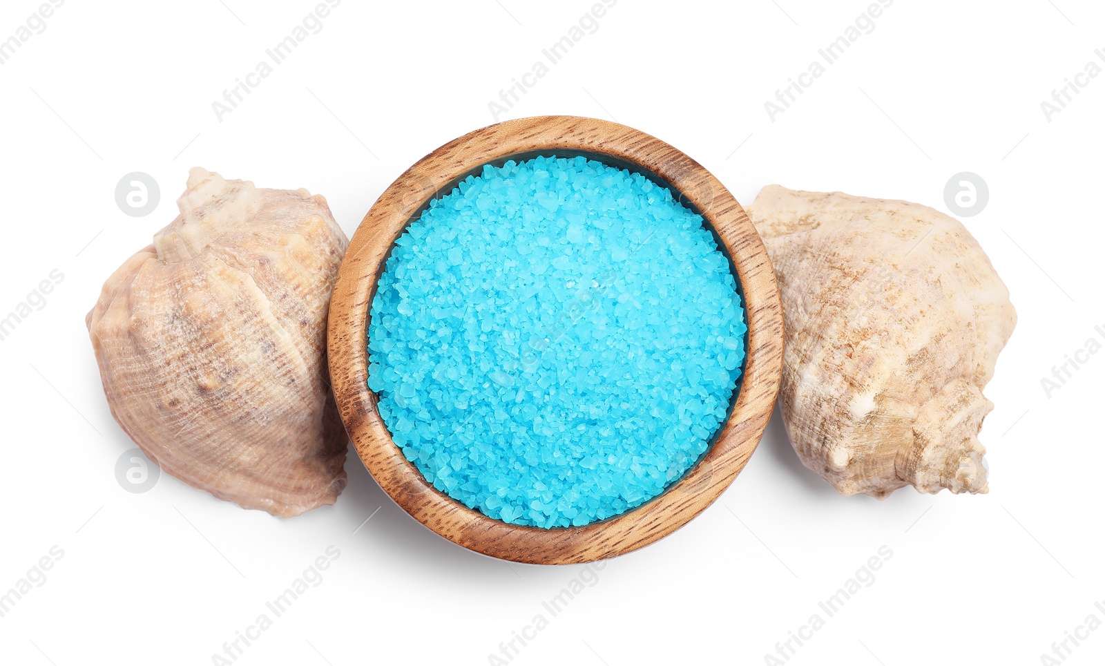 Photo of Light blue sea salt in bowl and shells isolated on white, top view