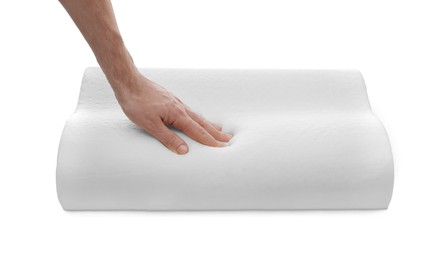 Photo of Man touching orthopedic memory foam pillow on white background, closeup