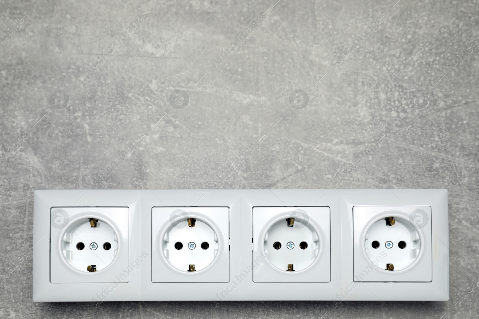 Photo of Modern plastic power socket on grey table, top view. Space for text