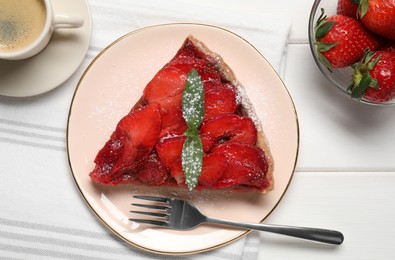 Piece of delicious strawberry tart with mint and coffee on white wooden table, flat lay