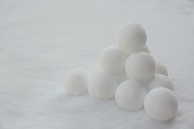 Pyramid of perfect snowballs on snow outdoors