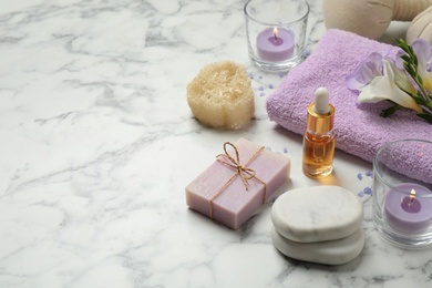 Photo of Spa composition with skin care products on white marble table, space for text