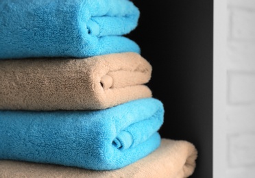 Photo of Stack of clean towels on shelf