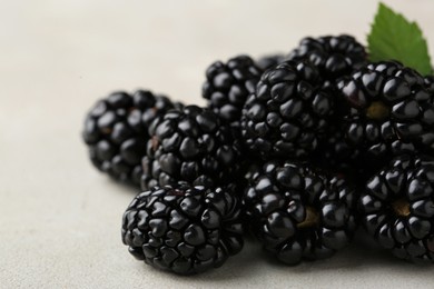 Pile of tasty ripe blackberries on white table, closeup
