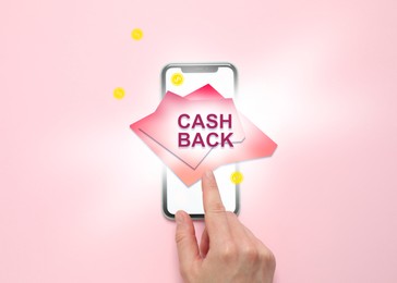 Image of Cashback. Woman using smartphone on pink background, top view. Illustration of coins and word