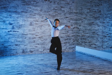 Beautifully dressed little boy dancing in studio