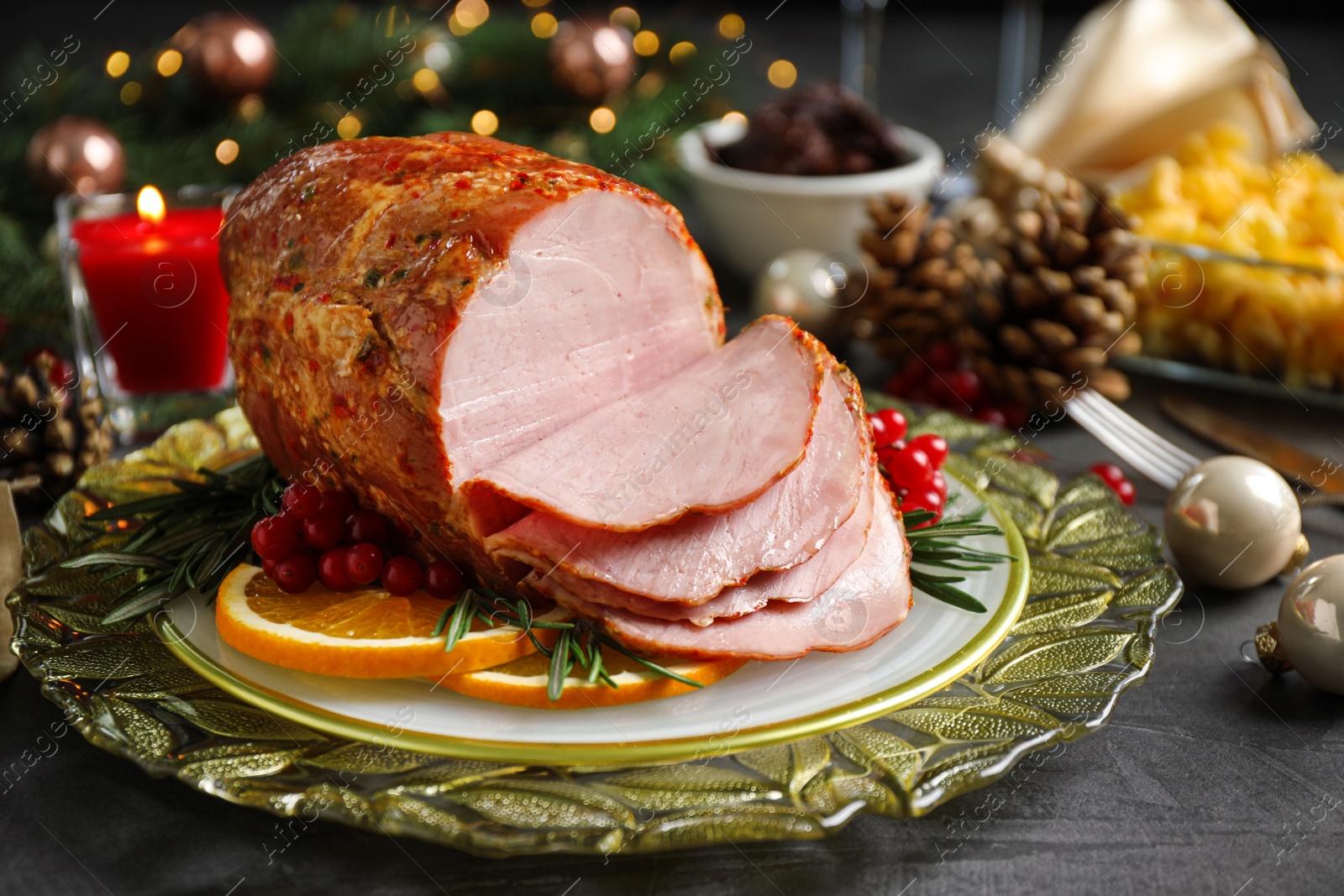 Photo of Plate with delicious ham served on grey table. Christmas dinner