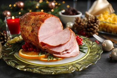 Plate with delicious ham served on grey table. Christmas dinner