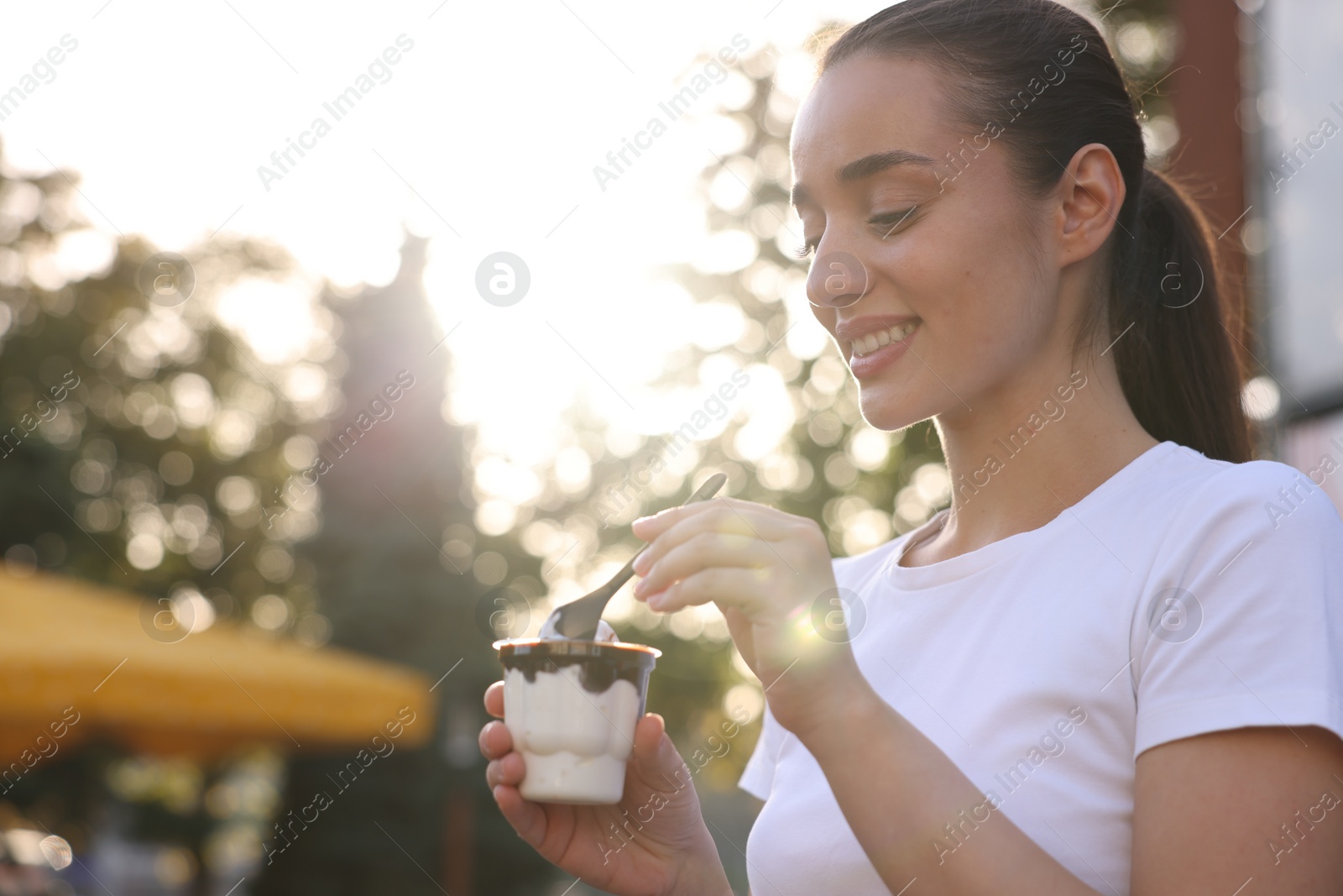 Photo of Lviv, Ukraine - September 26, 2023: Woman with McDonald's ice cream outdoors, space for text