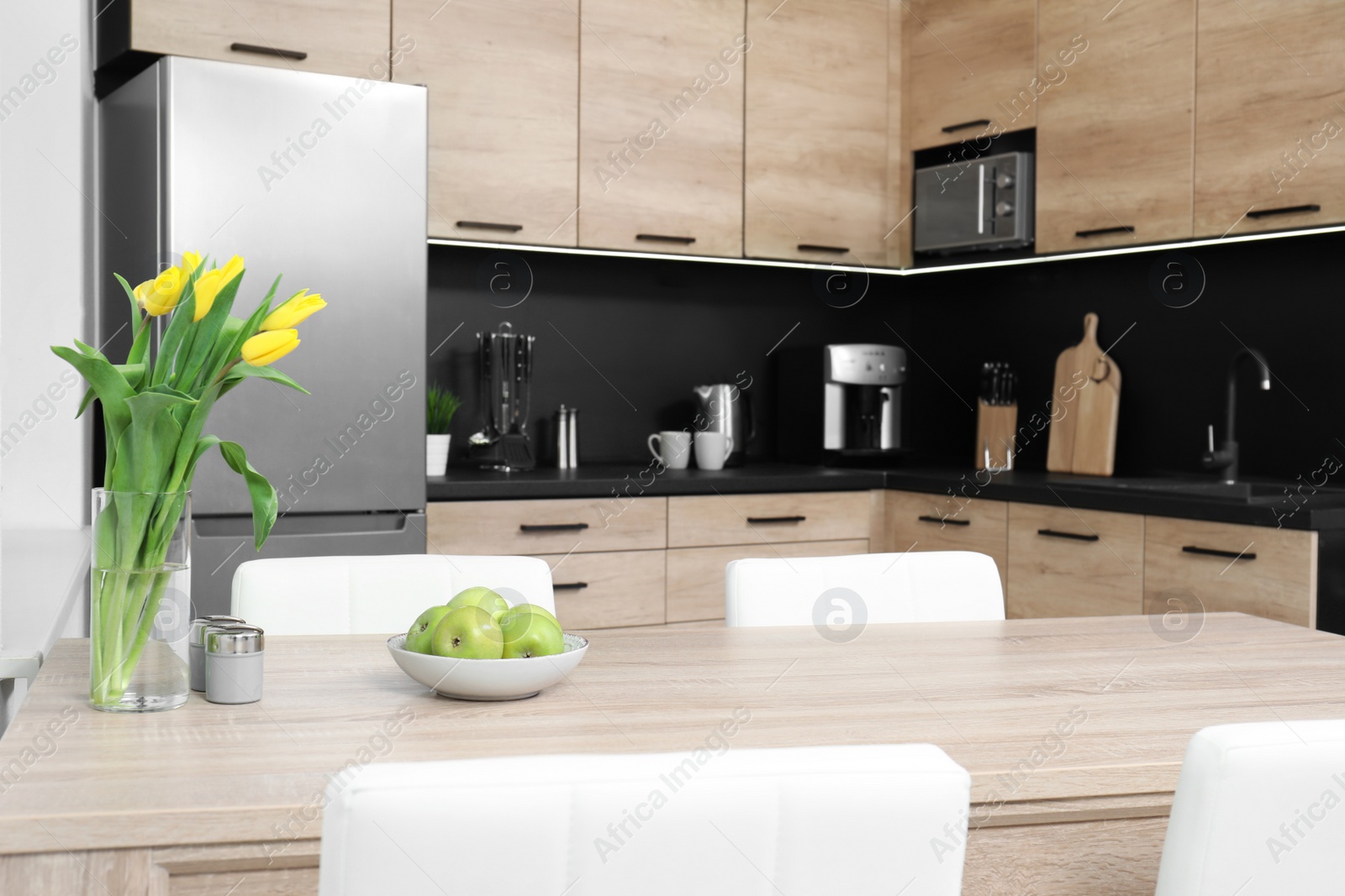 Photo of Cozy modern kitchen interior with new furniture and appliances