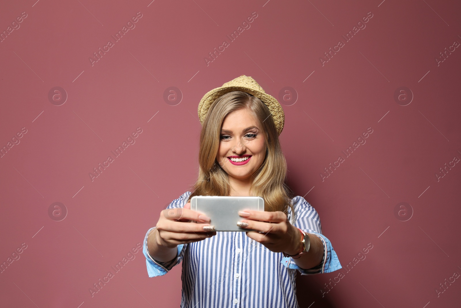 Photo of Attractive young woman taking selfie on color background