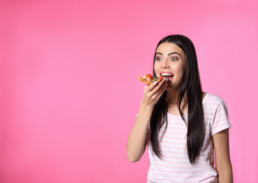 Emotional woman with pizza on pink background, space for text