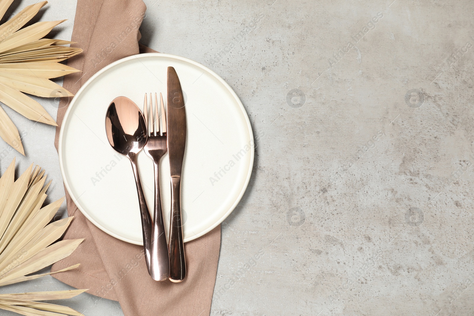 Photo of Setting with beautiful cutlery on textured table, top view. Space for text