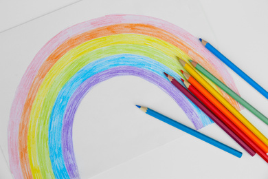 Photo of Painting of rainbow and pencils on white background, flat lay. Stay at home concept