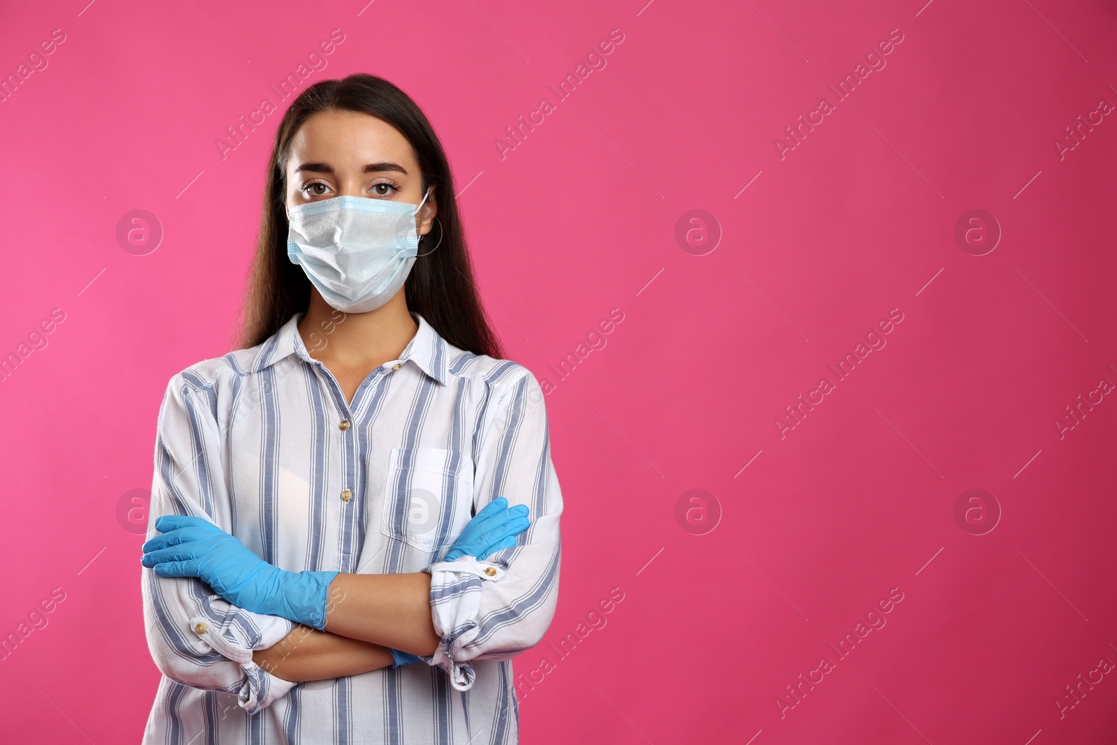 Photo of Woman wearing protective face mask and medical gloves on pink background. Space for text