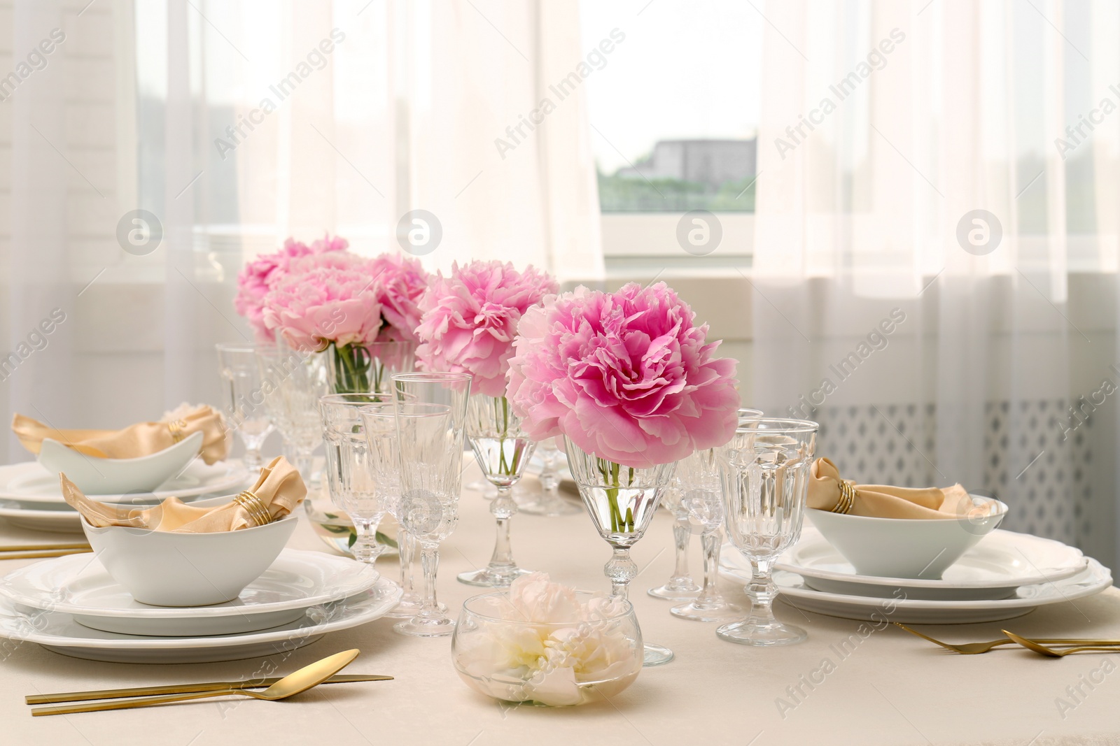 Photo of Stylish table setting with beautiful peonies and fabric napkins indoors