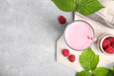 Photo of Glass of tasty raspberry smoothie on light table, flat lay. Space for text