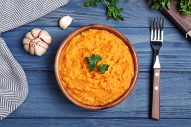 Photo of Flat lay composition with mashed sweet potatoes on wooden table