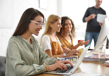 Photo of Team of professional designers working in office