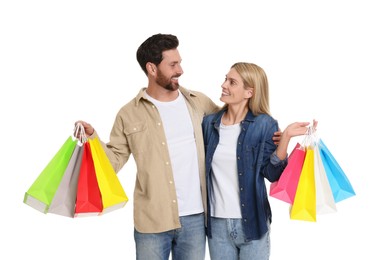 Photo of Family shopping. Happy couple with many colorful bags on white background