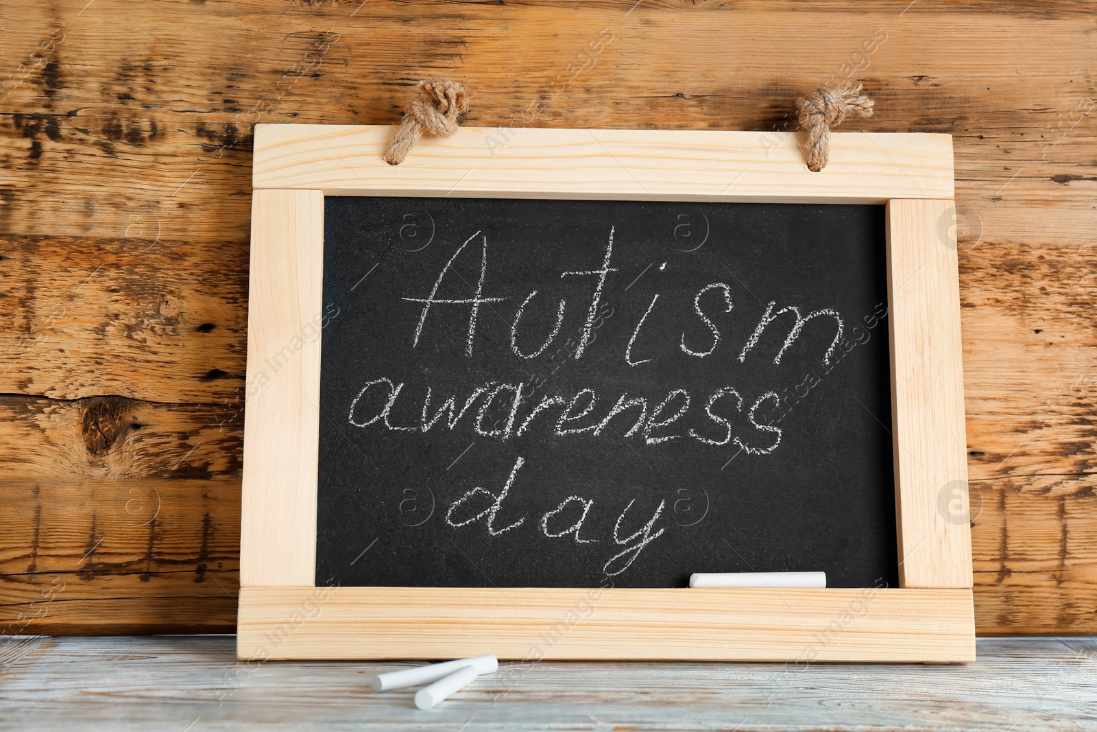 Photo of Chalkboard with phrase "Autism awareness day" on table