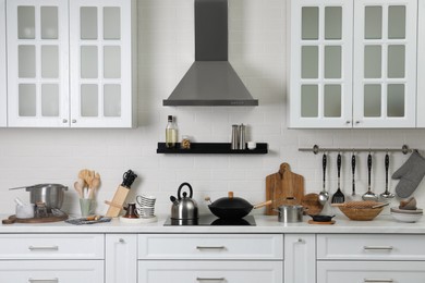 Photo of Countertop with different cooking utensils in kitchen