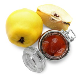 Tasty homemade quince jam in jar and fruits isolated on white, top view