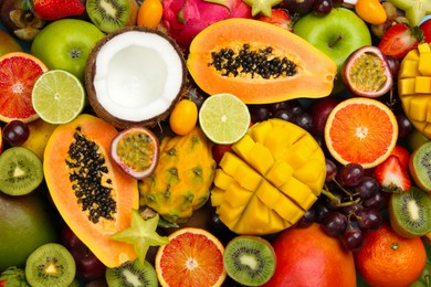 Photo of Many different delicious exotic fruits as background, top view