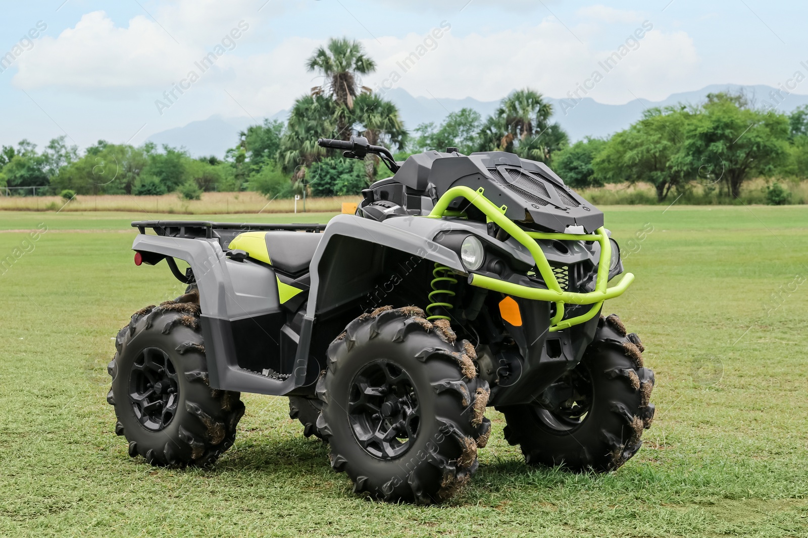 Photo of Modern quad bike on green grass outdoors