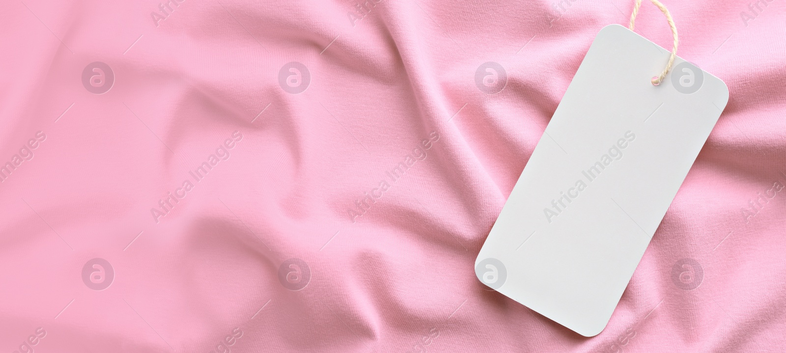 Image of Blank tag on pink fabric, top view with space for text. Banner design