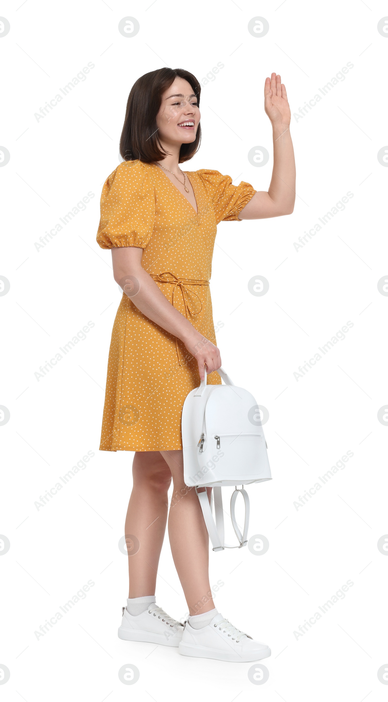 Photo of Happy woman in beautiful dress with backpack on white background