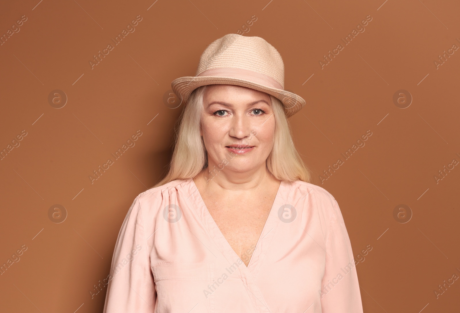 Photo of Portrait of beautiful mature woman on color background