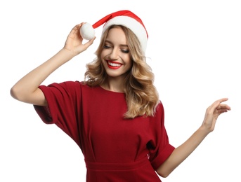 Happy young woman wearing Santa hat on white background. Christmas celebration